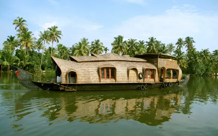 Traditional Kerala houseboat cruising through lush backwaters