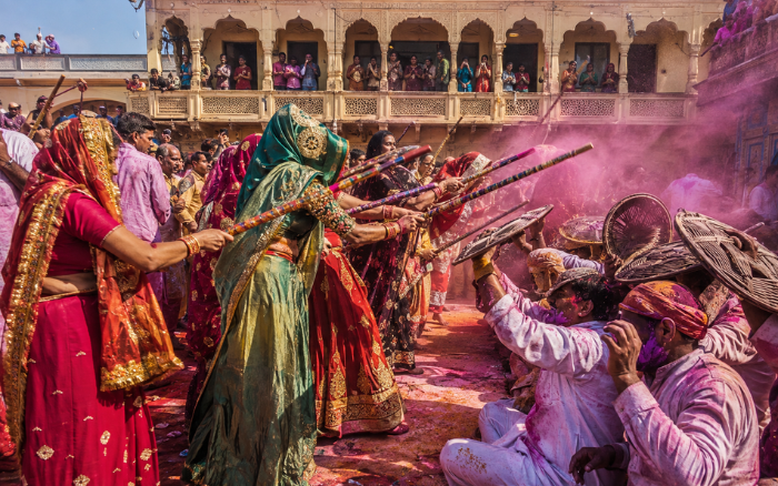Lathmar Holi celebration in Barsana with women holding sticks